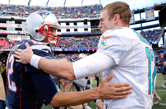 Tom Brady and Ryan Tannehill. Guess who got the better deal? (Jim Rogash/Getty Images)